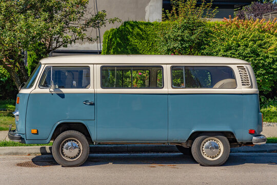 Vancouver, BC, Canada-September 5, 2024: Bright yellow  VW combi camper van parked on street.