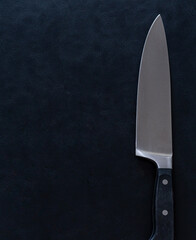 Sharp Kitchen Knife on Black Textured Background