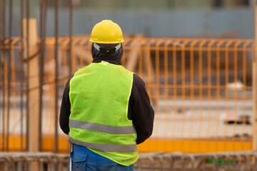 Worker with a yellow helmet at the construction  site
