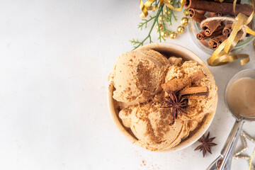 Portioned bowl with Christmas Eggnog ice cream scoops with cinnamon and spices, cold sweet gelato dessert for festive snack