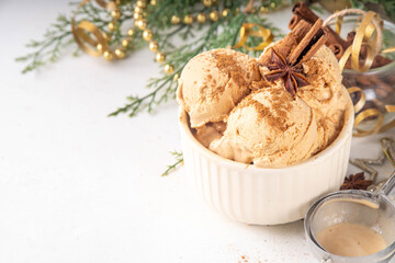 Portioned bowl with Christmas Eggnog ice cream scoops with cinnamon and spices, cold sweet gelato dessert for festive snack