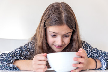 Girl with coffee. Angry girl drinking coffee at home.