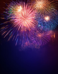 colorful fireworks explosions background in a dark blue sky