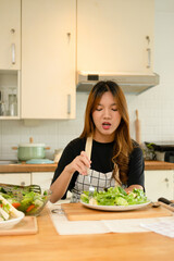 A female homecook enjoying her salad