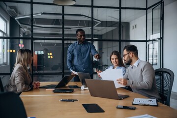 Business conception. Professional workers are in the modern office together