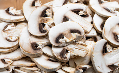 Sliced white mushrooms in close-up, showcasing their fresh texture and natural details, perfect for culinary or healthy lifestyle themes.