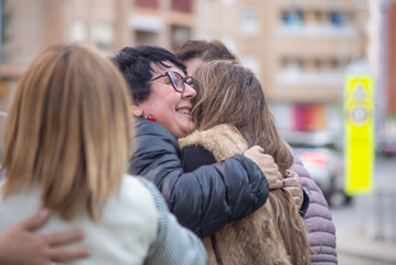 People hugging and greeting each other outdoors. Friends meeting, positive moments, bonding, togetherness