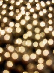 Christmas lights in bokeh. Outside in December. Red and fire orange bokeh on a black background.