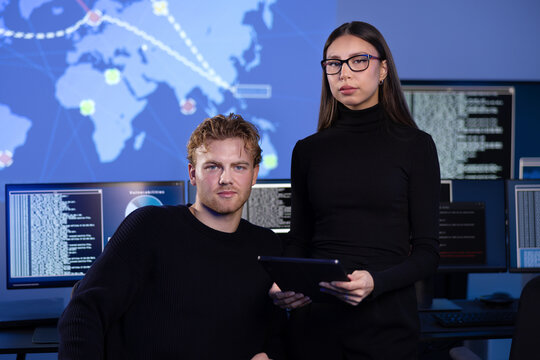 Professional serious cyber security team in front of cybersecurity SIEM system with logs and incident map - Powered by Adobe