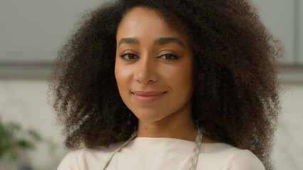 Portrait African American woman ethnic girl biracial female chef cooker baker mother housewife homeowner wife smiling posing in home modern kitchen interior wearing apron cooking food delivery cook