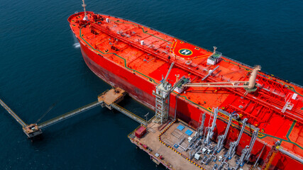 Aerial view oil tanker ship oil depot terminal storage petroleum petrochemical refinery product,...