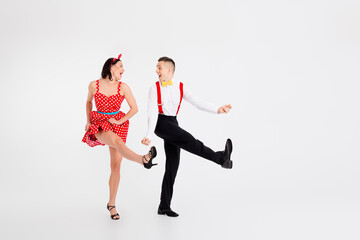 Full body portrait of two young funny partners good mood boogie dance isolated on white color...