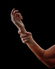 Female hands in raw clay on black