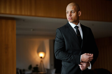Fototapeta premium Elegant african american businessman in suit looking away in business center