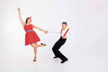 Full size portrait of two young rock and roll dancers performing isolated on white color background