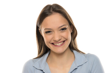 Portrait of a beautiful young happy woman with makeup on a white studio background