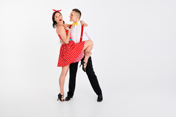 Full size portrait of two young rock and roll dancers empty space isolated on white color background