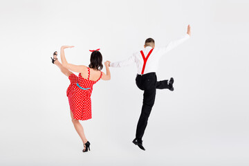 Full size rear portrait of two young rock and roll dancers have fun isolated on white color...