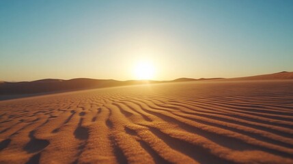 Naklejka premium Serene desert landscape at sunset with gentle sand dunes.