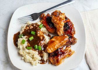 barbecue chicken wings with mash potatoes.