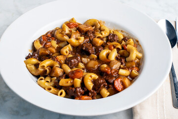 macaroni  mixed with beef stew