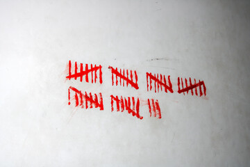 Crossed-out stripes on the old wall closeup