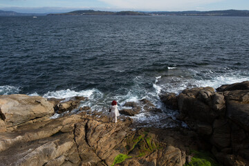 Woman considers the meaning of life looking out at the Mediterranean