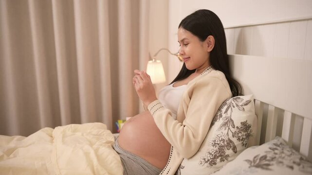 Pregnant woman holding positive pregnancy test