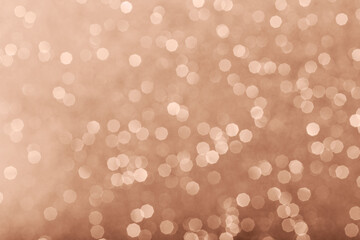 Mocha Mousse color of year 2025 glowing sparkles blurred background