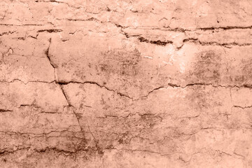 Closeup of a cracked stone wall with a brown brick pattern. Texture, background. Demonstrating color of the year 2025 - Mocha Mousse