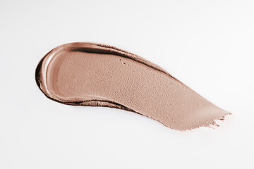 The texture of cream blush on a white background.