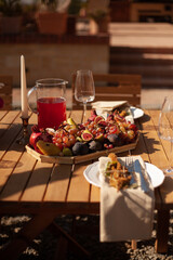 a set table with fruits and candles for a festive event in nature 