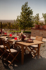 a set table for a festive event in nature among the vineyards