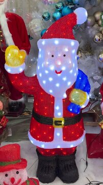 4k footage of interactive sparkling twinkle lights inside a santa claus doll replica. Interactive LED icicle lights for santa claus toy replica, suitable for kids christmas decoration.