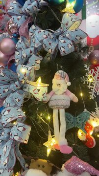 4k footage close up of lighted Christmas tree ornaments and decorations. Mistletoe, baubles, and bell with Interactive sparkling christmas twinkle lights or icicle lights.