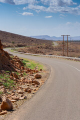 Long road through the Moroccan desert along the Atlas Mountains