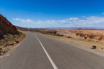 Long road through the Moroccan desert along the Atlas Mountains