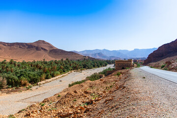 Long road through the Moroccan desert along the Atlas Mountains