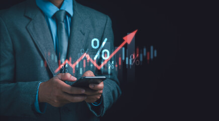 Interest rates and inflation, Debt rates, Finance concept, Businessman holding phone showing financial percentage and red graph. Central bank interest rate calculation increasing with economic growth