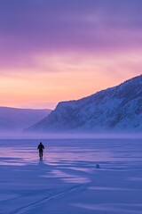 Solitary skier amidst stunning arctic sunrise over serene winter landscape