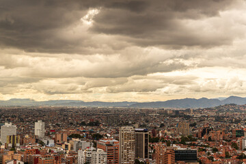 Atardecer dramático sobre Bogotá con nubes densas y paisaje urbano