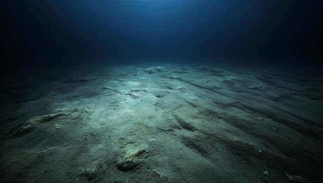 Mysterious underwater landscape. Dark, deep ocean floor with textured sand.