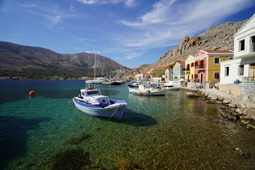 Fototapeta premium boats and clear water in the picturesque harbour of Symi island
