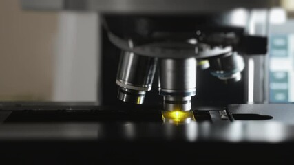 Changing lenses of a fluorescence microscope. Modern microscope. Modern scientific laboratory and equipment. Laboratory and medical equipment.