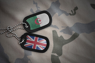 army blank, dog tag with national flag of algeria and great britain on the khaki texture...