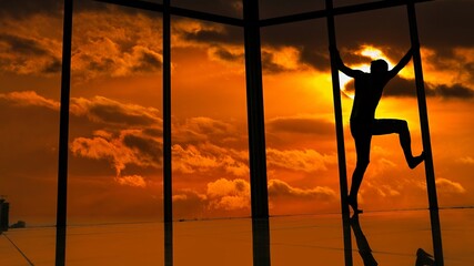 oy jumps walks on the glass 

behind the window sunset
man spider 