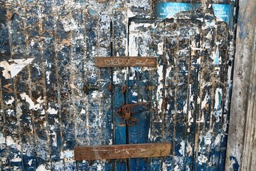 old door
paint coming off
full of colors 
locked