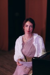 a portrait of a woman with notes at the piano