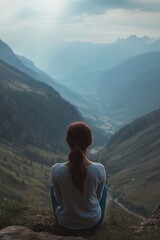 Naklejka premium Woman on rock overlooking valley