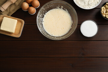 Different ingredients for cookies on wooden table, flat lay. Space for text
